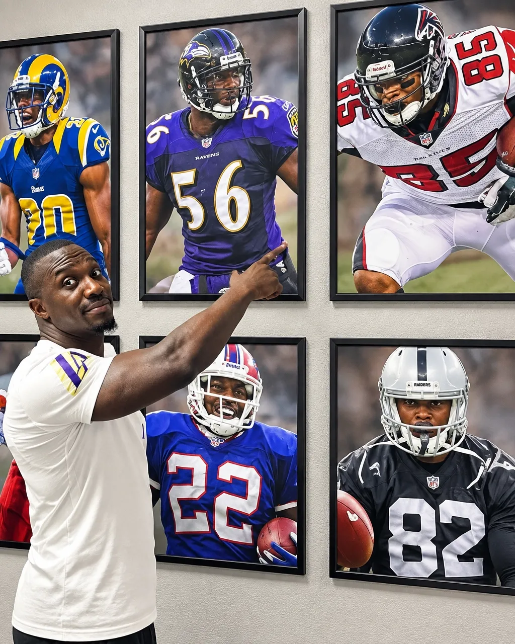 Tavares Gooden pointing toward framed NFL career photographs on a wall