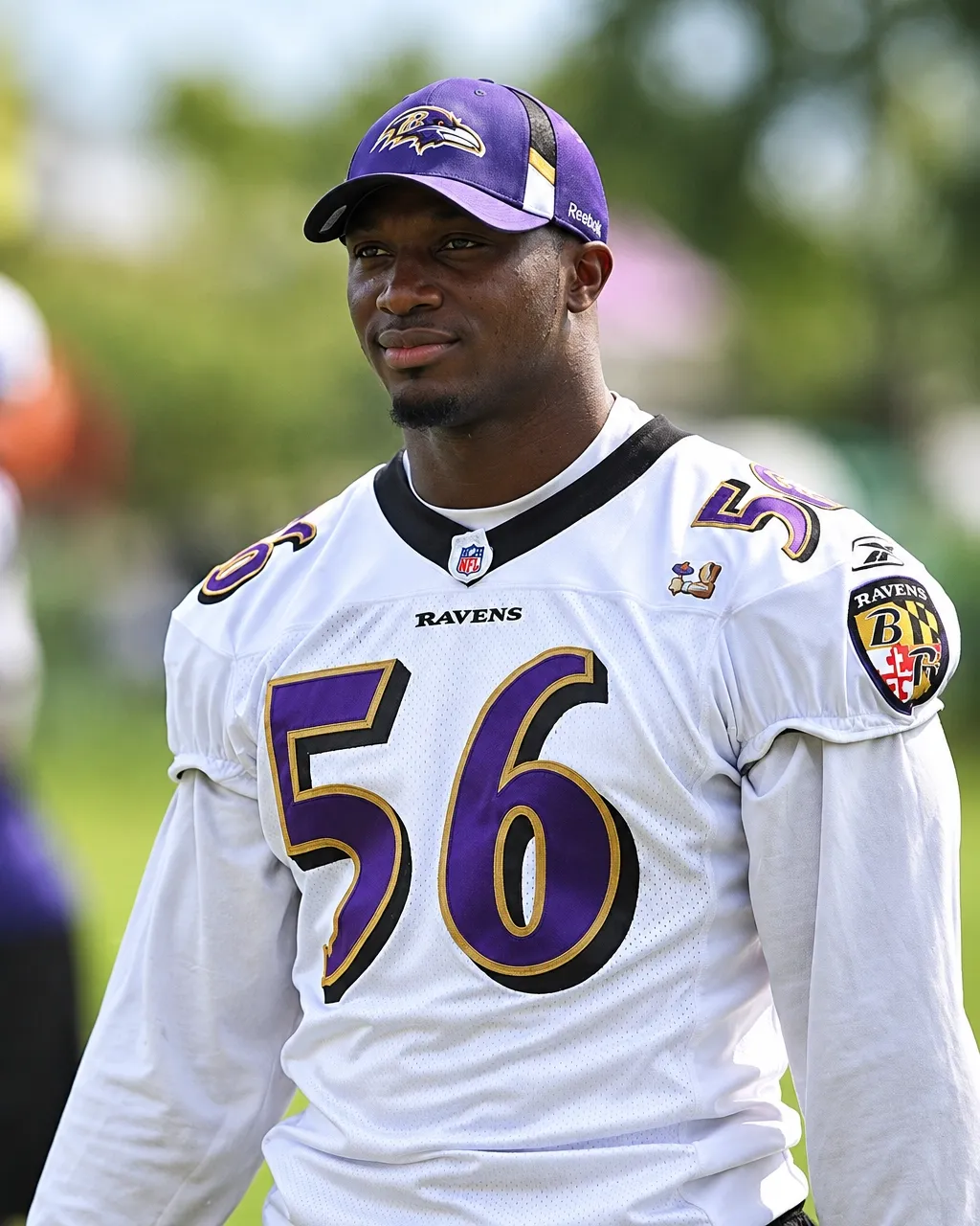 Tavares Gooden in a white Baltimore Ravens number 56 jersey and cap